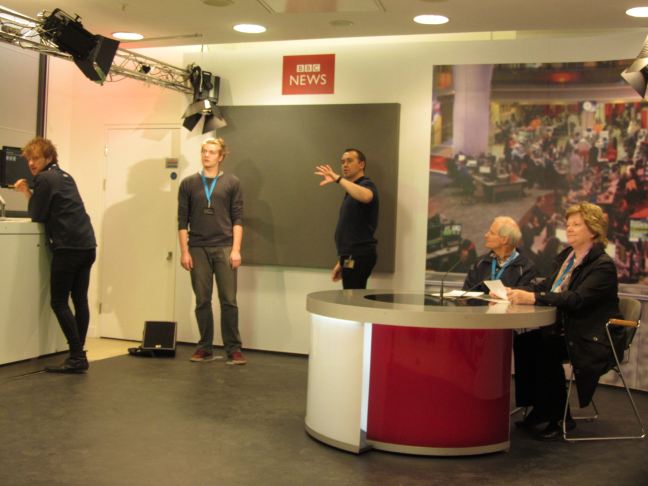 interior of the radio news studio with tour participants at the news desk